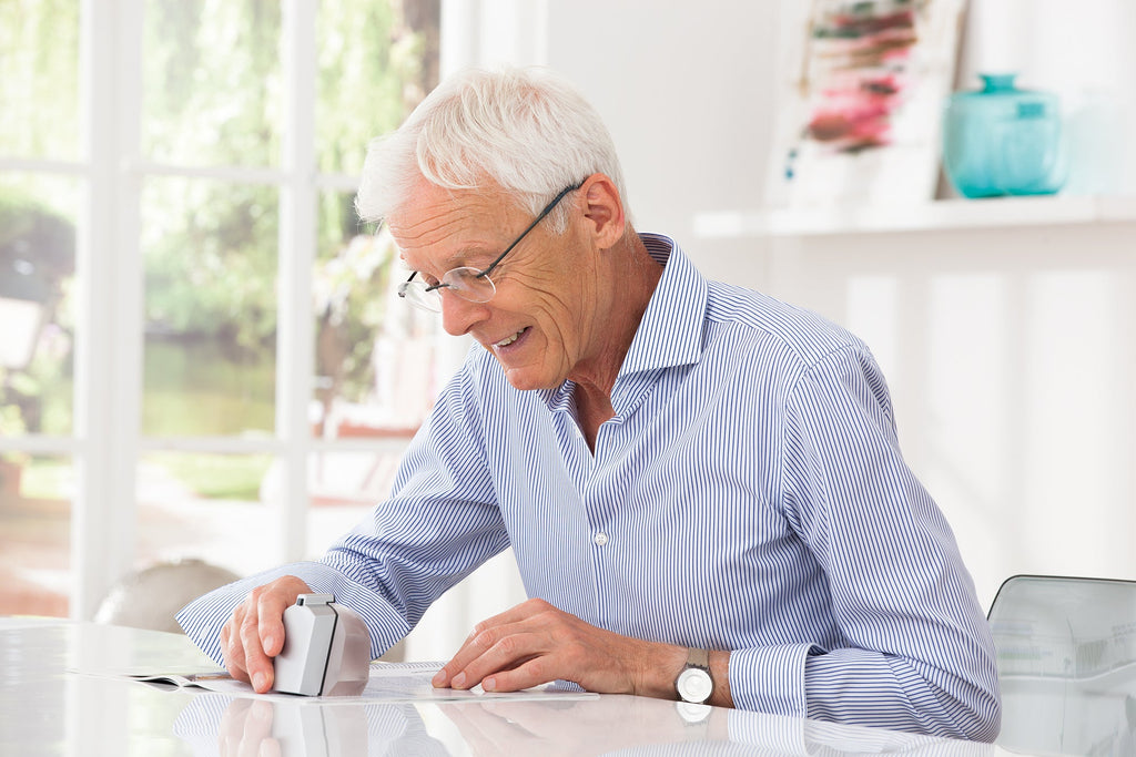 Man using segment magnifier to read