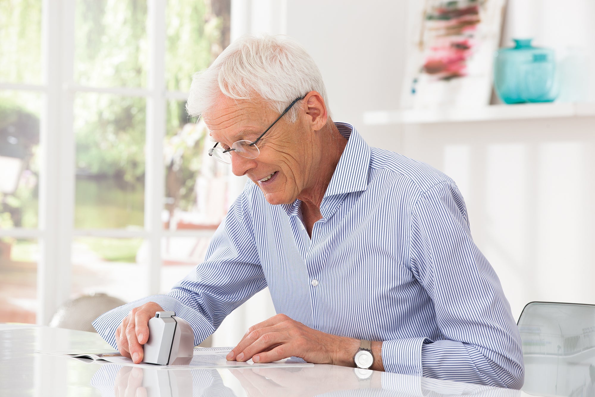Man using segment magnifier to read