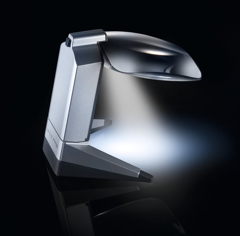 Scribolux, large rectangular lens suspended off of support base with LED light, displayed over crossword