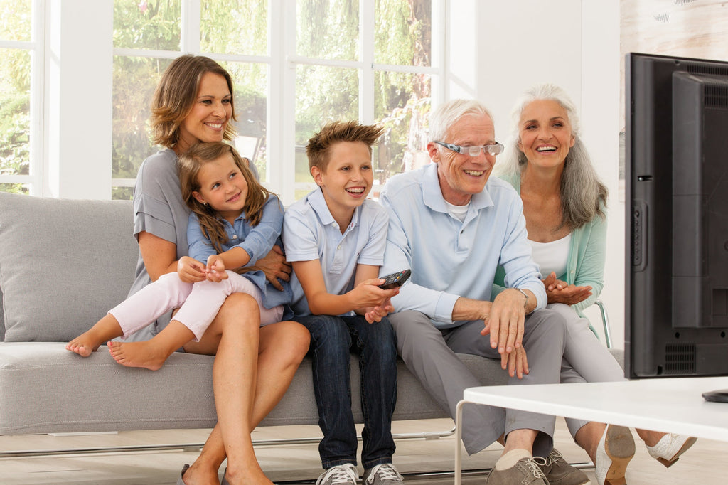 Man watching TV with MaxTV and his family 