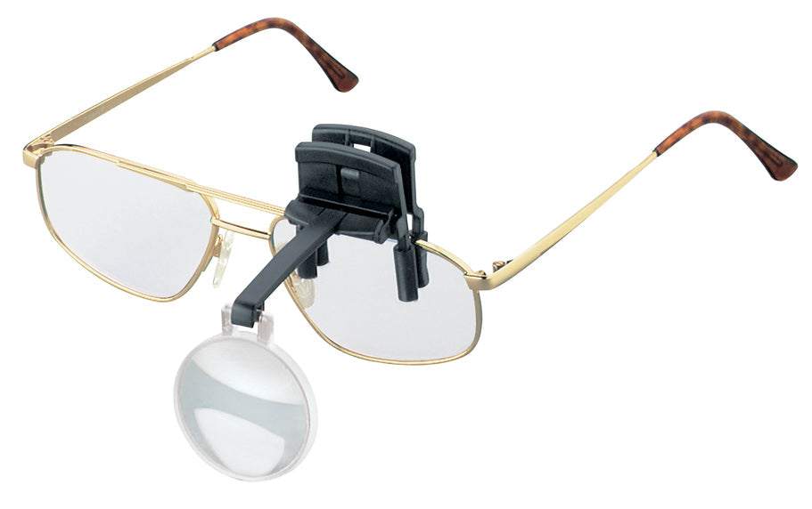Monocular (circular) lens on black arm and clip, attached to glasses.