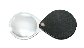 Circular magnifier inside clear oval setting, with attached fold-out black case